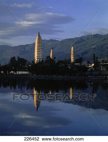 Stock Image - Pagodas reflected in river at dusk, China . Fotosearch