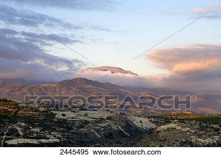 Panoramic view of mountain range at sunset, Mount Ida, Crete, Greece View Large Photo Image Stock Photography - Panoramic view of mountain range at sunset, Mount Ida, Crete, Greece . Fotosearch