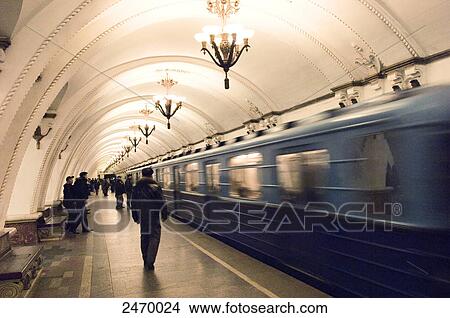 Picture - Passengers at subway station, Arbatskaya, Arbatskoâ€“Pokrovskaya Line, Moscow, Russia . Fotosearch
