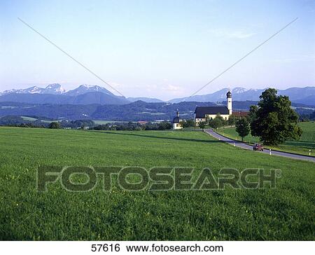 Stock Photograph - Path running through rural landscape, Pilgrimage church, Wilparting, Irschenberg, Bavaria, Germany . Fotosearch