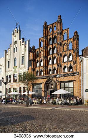 Pavement cafe in front of an old warehouse (Alter Schwede), Wismar, Germany View Large Photo Image Stock Photography - Pavement cafe in front of an old warehouse (Alter Schwede), Wismar, Germany . Fotosearch