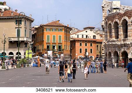 Stock Image - Pedestrians at a square (Piazza Bra) next to the amphitheatre, Verona, Italy . Fotosearch
