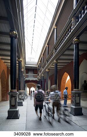 Stock Photo - Pedestrians in a passageway, Stralsund, Germany . Fotosearch