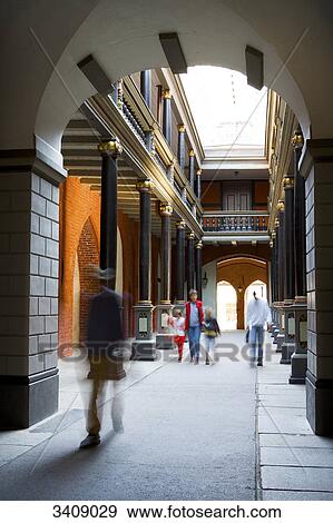 Stock Photo - Pedestrians in a passageway, Stralsund, Germany . Fotosearch