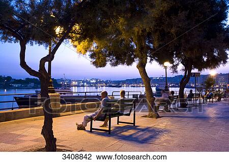 Pedestrians on a promenade in Sliema, Malta View Large Photo Image Stock Image - Pedestrians on a promenade in Sliema, Malta . Fotosearch