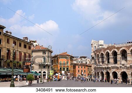 Stock Image - Pedestrians on a square (Piazza Bra) at the amphitheatre, Verona, Italy . Fotosearch