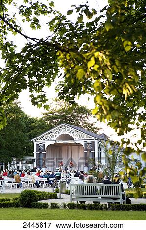 People enjoying spa concert in park, Mecklenburg-West Pomerania, Berlin, Germany View Large Photo Image Stock Photo - People enjoying spa concert in park, Mecklenburg-West Pomerania, Berlin, Germany . Fotosearch
