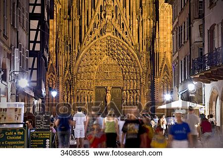 Stock Photography - People in an alley (Rue Merciere), Strasbourg Cathedral in the background, Strasbourg, France . Fotosearch