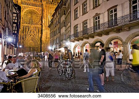 Stock Photograph - People in an alley, Strasbourg Cathedral in the background, Strasbourg, France . Fotosearch