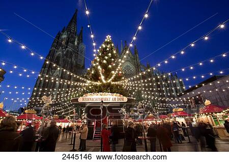 Stock Photograph - People in front of church at Christmas time, Cologne Cathedral, Cologne, North Rhine-Westphalia, Germany . Fotosearch