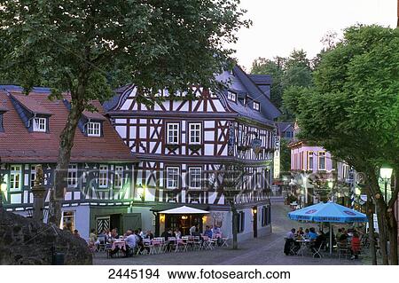 People in sidewalk cafe at dusk, Idstein, Darmstadt, Hesse, Germany View Large Photo Image Picture - People in sidewalk cafe at dusk, Idstein, Darmstadt, Hesse, Germany . Fotosearch