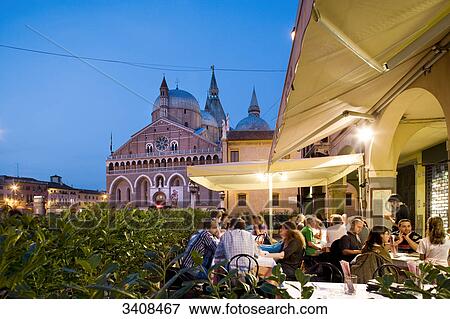 Stock Photo - People sitting in a restaurant, Basilica di Sant Antonio in the background, Padua, Italy . Fotosearch