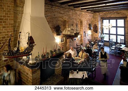 Stock Image - People sitting inside restaurant, Germany . Fotosearch