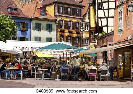 People sitting outside a restaurant, Colmar, France View Large Photo Image Stock Photo - People sitting outside a restaurant, Colmar, France . Fotosearch
