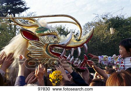 Stock Image - People touching golden dragon in festival, Senso-ji Temple, Asakusa, Tokyo, Japan . Fotosearch