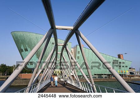 People walking on footbridge, Oosterdock, Amsterdam, Netherlands View Large Photo Image Stock Photo - People walking on footbridge, Oosterdock, Amsterdam, Netherlands . Fotosearch