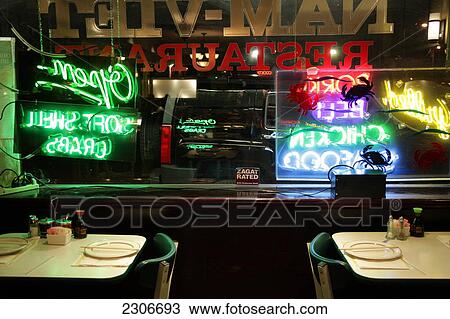 Stock Image - Plates and chopsticks on tables in restaurant, USA . Fotosearch