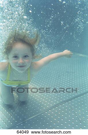 Stock Photo - Portrait of girl swimming underwater in a pool . Fotosearch
