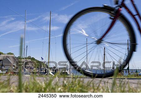 Rear tire of bicycle in front of boasts moored at harbor View Large Photo Image Stock Image - Rear tire of bicycle in front of boasts moored at harbor . Fotosearch