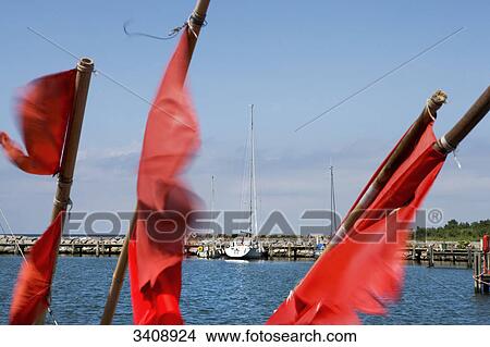 Red flags at the port of Timmendorf, Poel Island, Germany View Large Photo Image Picture - Red flags at the port of Timmendorf, Poel Island, Germany . Fotosearch