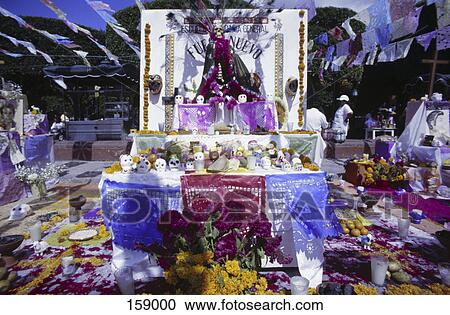 Stock Image - Religious offerings made on decorative stage during social function, San Miguel de Allende, Mexico . Fotosearch