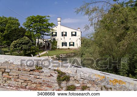 Residential house on a riverbank, Torcello, Venetia, elevated view View Large Photo Image Stock Photo - Residential house on a riverbank, Torcello, Venetia, elevated view . Fotosearch