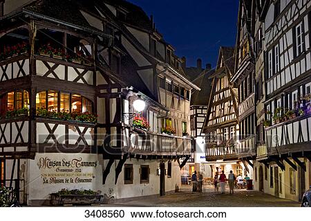 Stock Image - Restaurant Maison de Tanneurs and half-timbered houses in an alley, Petite France, Strasbourg, France . Fotosearch