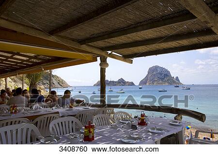 Restaurant patio, view of the rocky island Es Vedra, Ibiza, Spain View Large Photo Image Stock Image - Restaurant patio, view of the rocky island Es Vedra, Ibiza, Spain . Fotosearch