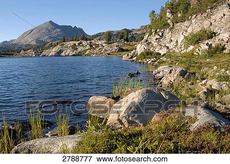 Stock Photo - River flowing through landscape, Wyoming, USA . Fotosearch