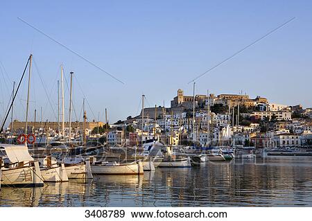 Stock Photo - Row of boats in the harbour in front of the old town, Ibiza Stadt, Ibiza, Spain . Fotosearch
