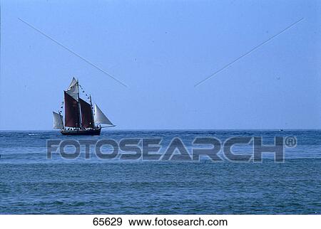 Sailboat in sea against blue sky View Large Photo Image Stock Photo - Sailboat in sea against blue sky . Fotosearch