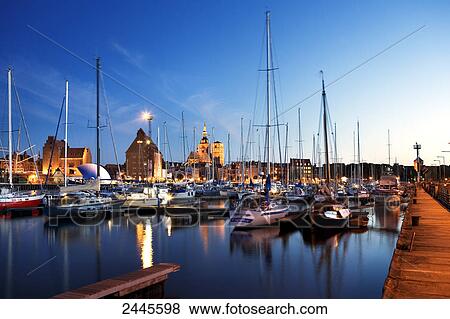 Stock Photo - Sailboats at harbor with church in background, St. Nikolai Russian Church, Stralsund, Mecklenburg-West Pomerania, Germany . Fotosearch