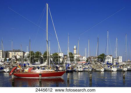 Sailboats at harbor with city in background, Rostock, Warnemunde, Mecklenburg-West Pomerania, Berlin, Germany View Large Photo Image Stock Image - Sailboats at harbor with city in background, Rostock, Warnemunde, Mecklenburg-West Pomerania, Berlin, Germany . Fotosearch