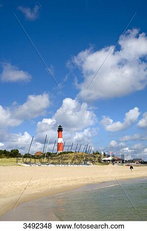 Sailing boats on a beach, lighthouse in the background, Hörnum, Sylt, Schleswig-Holstein, Germany View Large Photo Image Stock Photo - Sailing boats on a beach, lighthouse in the background, Hörnum, Sylt, Schleswig-Holstein, Germany . Fotosearch