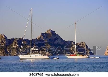 Sailing yachts in front of a rocky island (Es Vedra), Ibiza, Spain View Large Photo Image Stock Photography - Sailing yachts in front of a rocky island (Es Vedra), Ibiza, Spain . Fotosearch