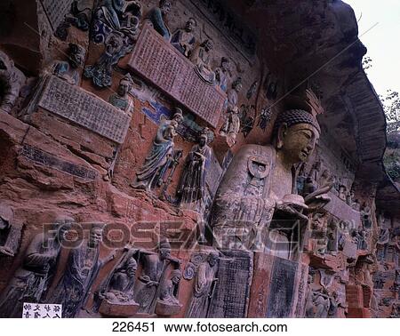 Stock Image - Sculptures caved on rock face, Dazu Grottoes, Chongqing, China . Fotosearch
