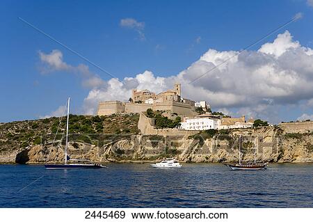 Stock Photo - Sea with town in background, Dalt Vila, Ibiza, Balearic Islands, Spain . Fotosearch