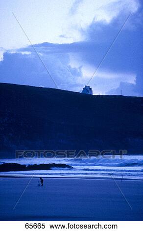 Stock Photography - Silhouette of man on beach, Baie de Trespasse, Finistere, Brittany, France . Fotosearch