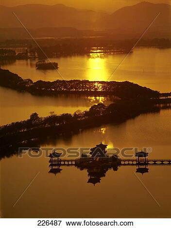 Stock Photo - Silhouette of pagodas and trees in river at dusk, China . Fotosearch