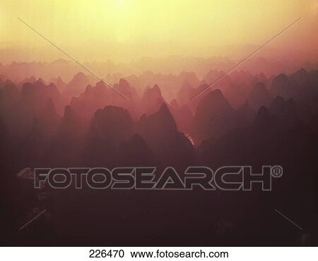 Stock Image - Silhouette of rock formations at dusk, China . Fotosearch