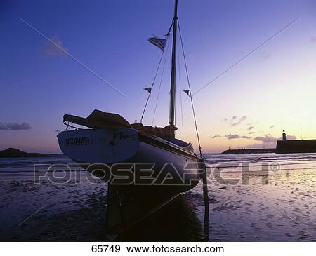 Silhouette of sailboat on beach, Port Erquy, Brittany, France View Large Photo Image Stock Photo - Silhouette of sailboat on beach, Port Erquy, Brittany, France . Fotosearch