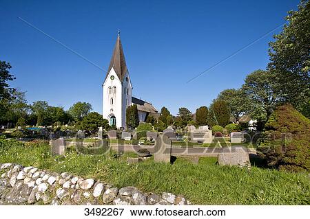 Stock Photo - St. Clement Church and cemetery, Nebel, Amrum, Germany . Fotosearch