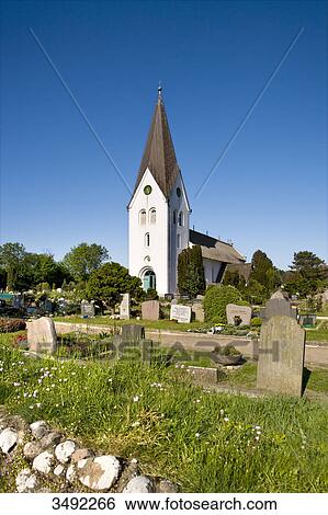 Stock Photograph - St. Clement Church and cemetery, Nebel, Amrum, Germany . Fotosearch