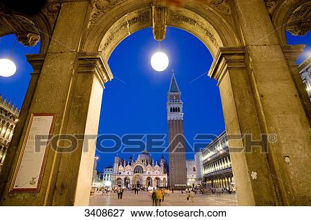 Stock Photo - St. Marcus Square seen through an arch, Venice, Italy, low angle view . Fotosearch