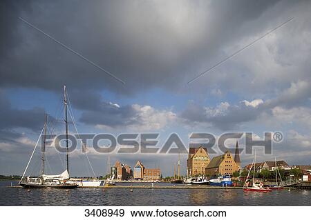 Storm clouds above the Warnow river, warehouses in the background, Rostock, Germany View Large Photo Image Stock Photo - Storm clouds above the Warnow river, warehouses in the background, Rostock, Germany . Fotosearch