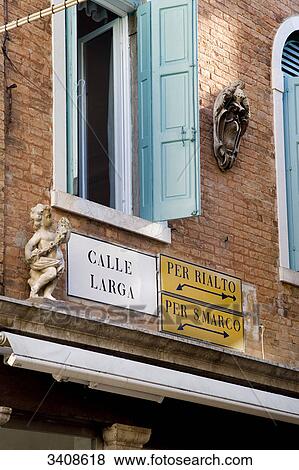 Street sign and guideposts on a house facade, Venice, Italy, low angle view View Large Photo Image Stock Photo - Street sign and guideposts on a house facade, Venice, Italy, low angle view . Fotosearch