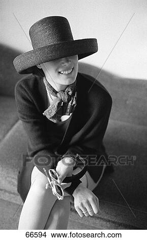 Stylish woman sitting on sofa View Large Photo Image Picture - Stylish woman sitting on sofa . Fotosearch