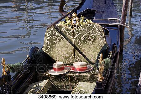 Stock Photo - Sunhats on the seat of a Gondola, Venice, Italy, elevated view . Fotosearch