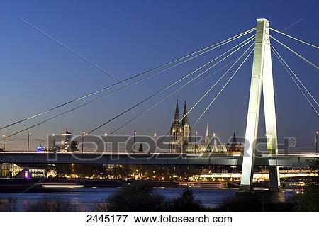 Suspension bridge across river with church in background, Severinsbruecke, Rhine River, Cologne Cathedral, Cologne, North Rhine-Westphalia, Germany View Large Photo Image Stock Photo - Suspension bridge across river with church in background, Severinsbruecke, Rhine River, Cologne Cathedral, Cologne, North Rhine-Westphalia, Germany . Fotosearch