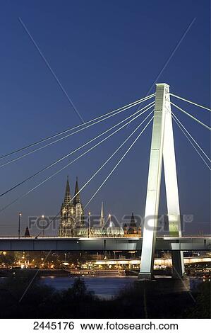 Suspension bridge across river with church in background, Severinsbruecke, Rhine River, Cologne Cathedral, Cologne, North Rhine-Westphalia, Germany View Large Photo Image Stock Photograph - Suspension bridge across river with church in background, Severinsbruecke, Rhine River, Cologne Cathedral, Cologne, North Rhine-Westphalia, Germany . Fotosearch